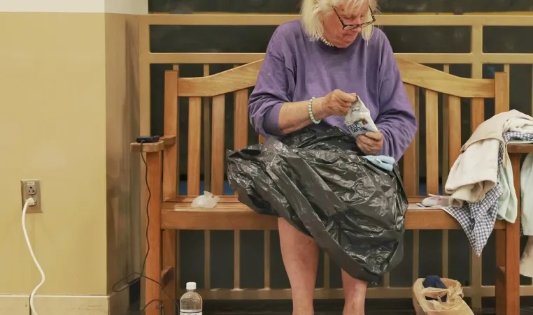 woman charging phone and recharging at YMCA of Western NC's Reuter Family YMCA